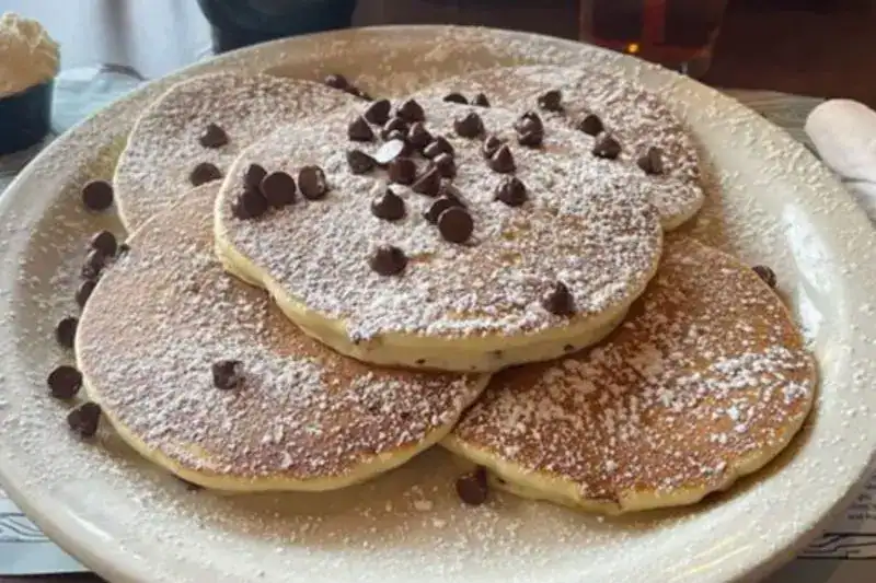Stack of fluffy pancakes with syrup 