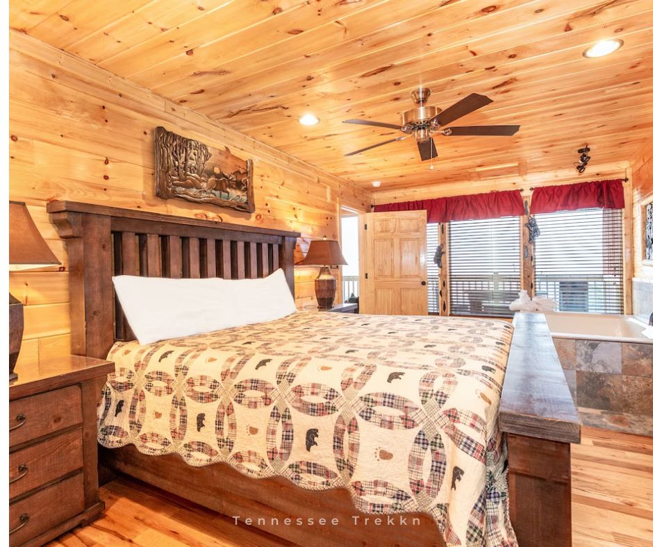 Sully’s Mountain Cabin Retreat: Relax in the cozy bedroom, complete with an in-room jacuzzi for two. Pigeon Forge Cabin Rentals in TN