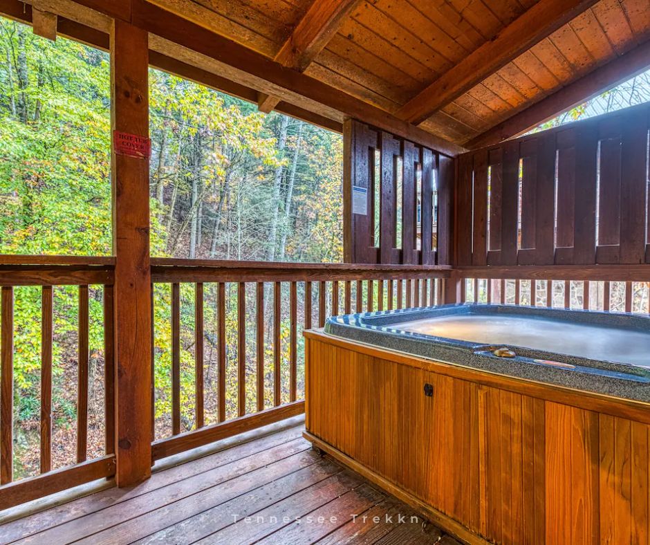 Blackberry Cobbler Cabin: After a day of exploring, unwind in the HOT TUB with peaceful wooded views.