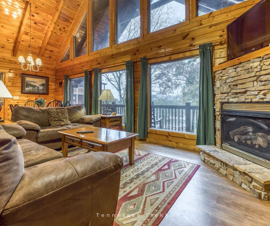 Blackberry Cobbler Cabin: Relax by the cozy fireplace while soaking in the views through the wall of windows.