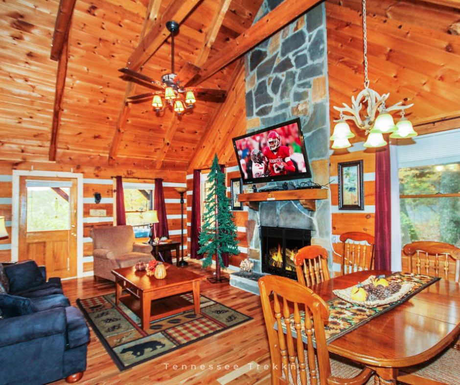 Smoky’s Mountain View Cabin: Relax by the fireplace in the cozy living and dining area after your adventures. 