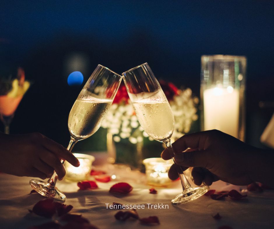 Romantic candlelit dinner with a couple toasting champagne. Perfect way to celebrate Valentine's Day in Gatlinburg.