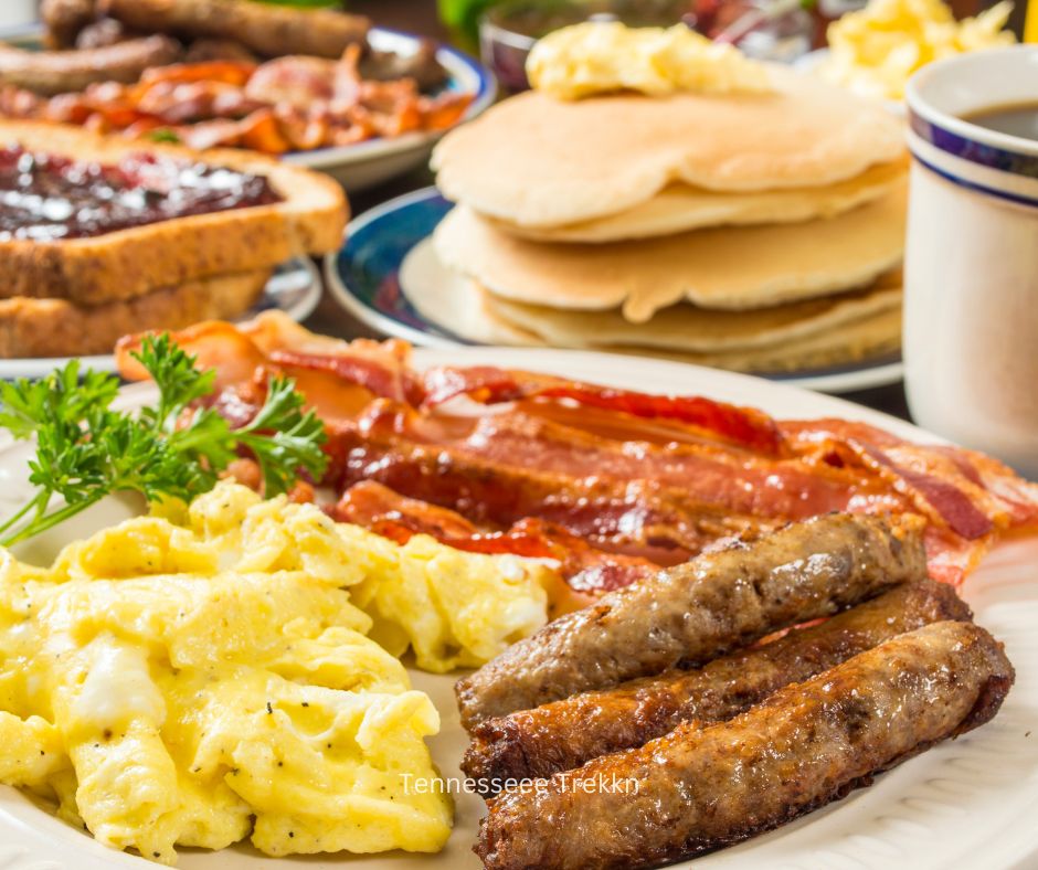 Southern breakfast with pancakes, sausage, eggs, and other classic dishes.