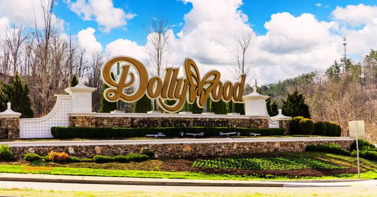 The Dollywood entrance sign with flowers and mountains in the background, representing the ultimate guide to Dollywood tickets, festivals, and visitor tips.