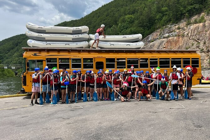 White water rafting in Chattanooga TN.   Rafting group ready for adventure with their oars and rafts in front of bus.