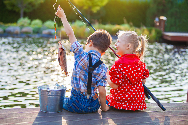 Little boy and girl fishing in pond in the Smoky Mountains.  Pigeon Forge Camping, Tennessee