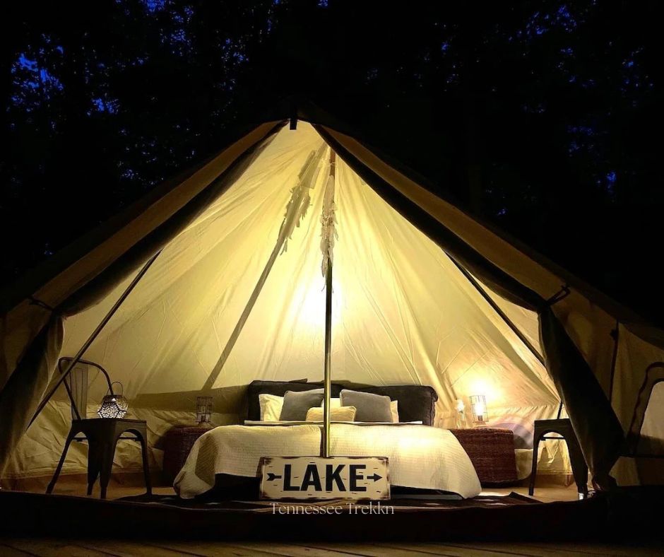 Relax under the stars in this cozy lakeside tent, beautifully lit for the perfect evening. Tennessee Glamping Book your stay HERE!