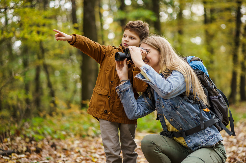 mom and son looking through binoculars while hiking; fun things to do while hiking with kids in Tennessee.