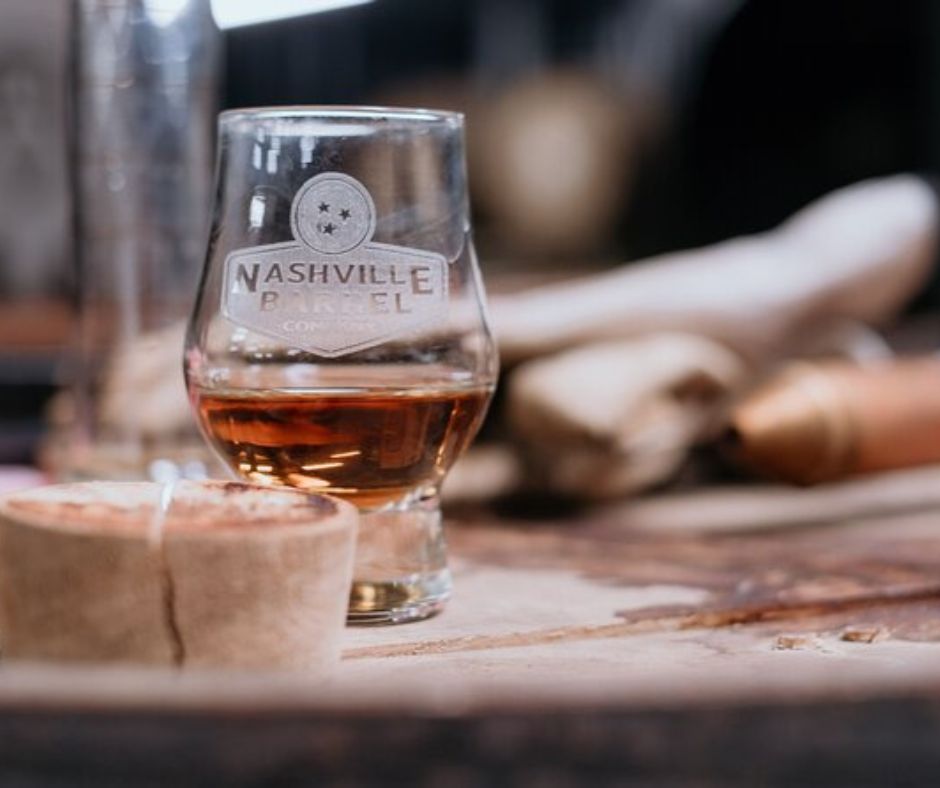 Whiskey Glass on wood table, Straight from the Barrel tastings tour in Nashville, Tennessee Whiskey Tours