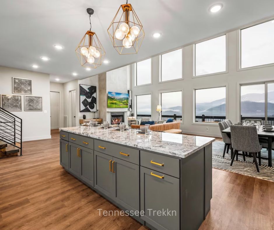 Luxury kitchen and dining area at WatchTower with a wall of windows and mountain views.