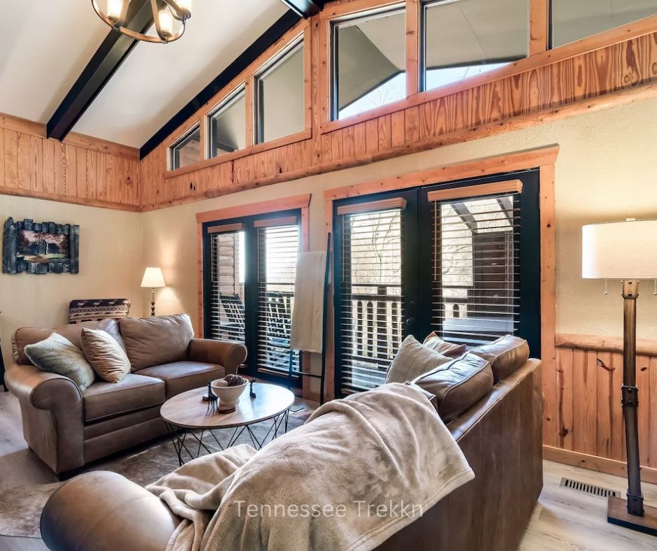 Cozy living room at Mountain Memories cabin with doors leading to deck. Chalet Village Gatlinburg Cabin