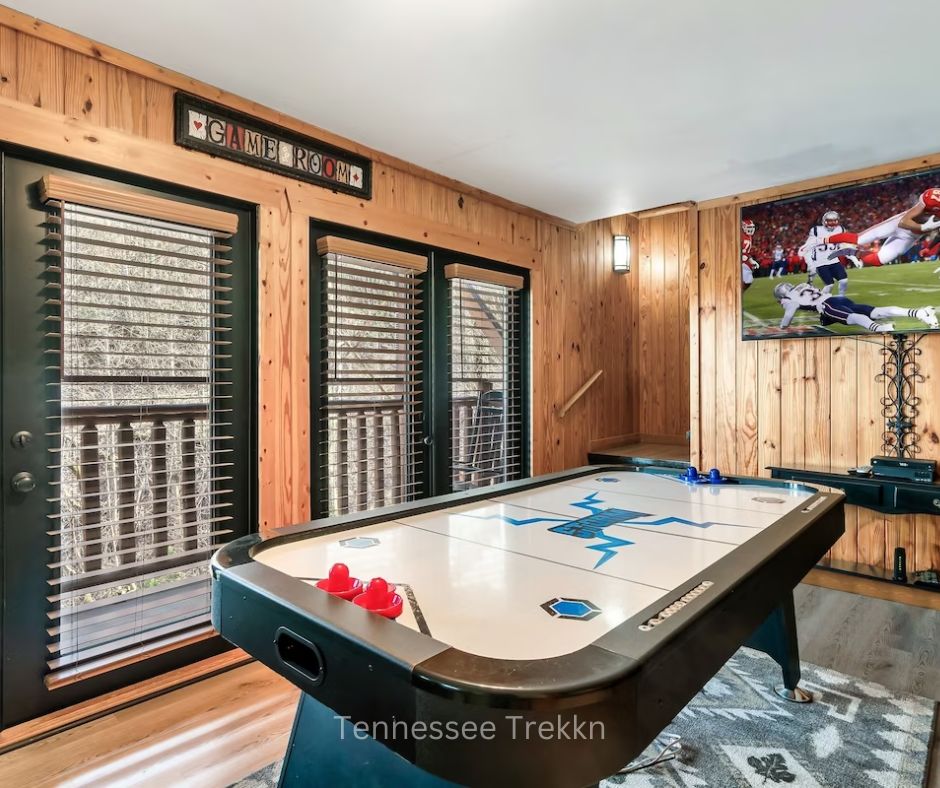 Game room at Mountain Memories cabin with foosball table and seating.