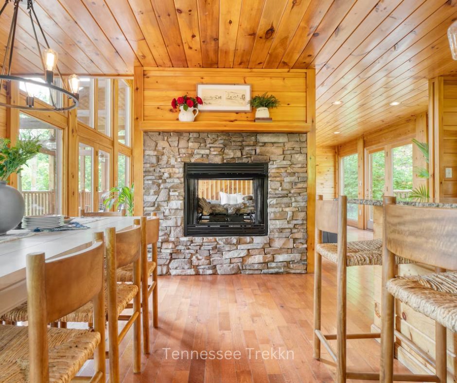 Open kitchen at Hollows Haven with a fireplace, mountain views, and large windows.