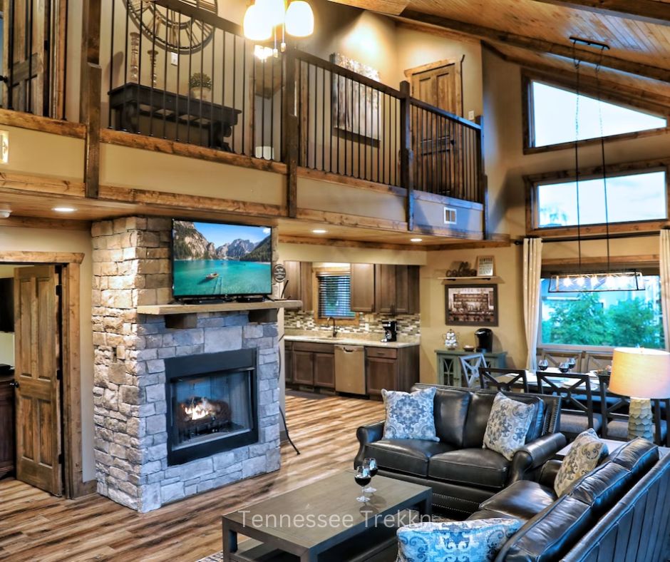 Living room at Longview Lodge with large windows, mountain views, and cozy fireplace.