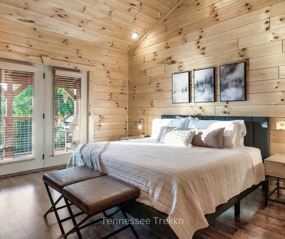 Bedroom with direct deck access and beautiful mountain views at Cliffhanger Cabin.