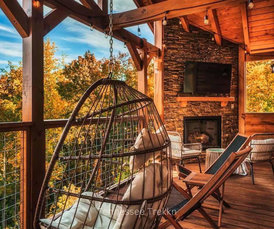 Outdoor fireplace area with seating and scenic mountain views at Cliffhanger Cabin. Chalet Village Gatlinburg Cabin.