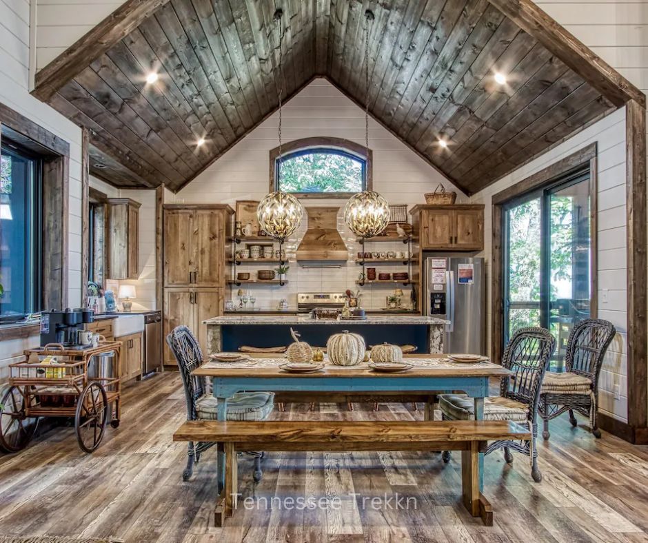 Dining area and modern kitchen at Yonder Mountain Lodge with rustic luxury decor.