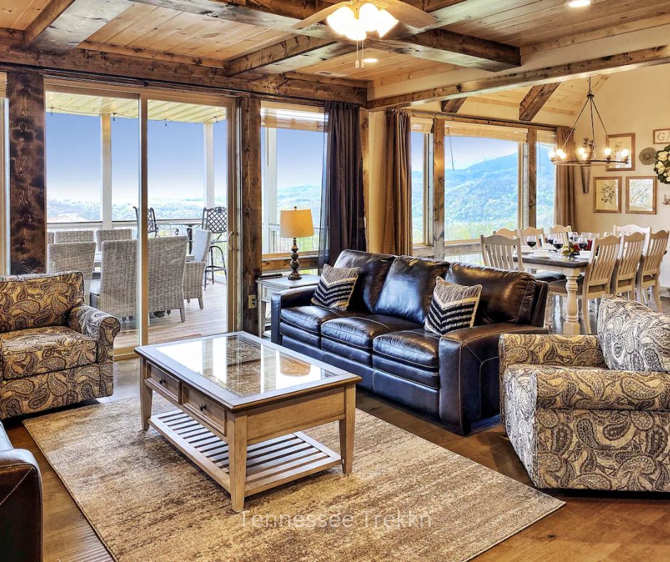 Living room at Heaven’s Perch cabin with large windows showcasing Smoky Mountain views. Chalet Village Gatlinburg Cabin.