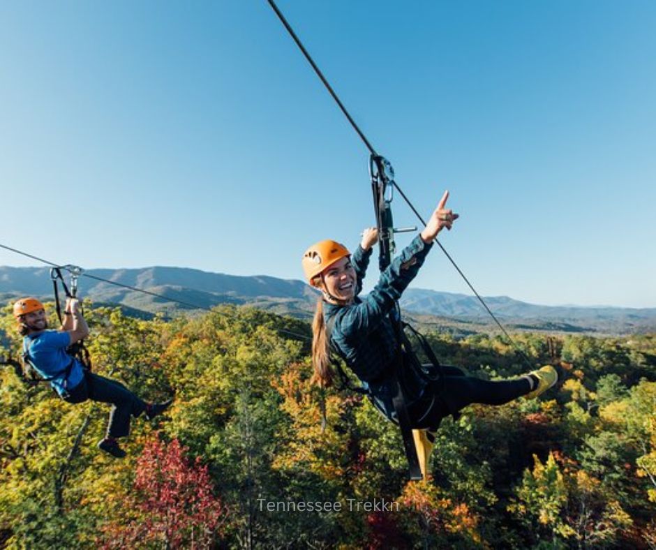 Adventurers ziplining through the Smoky Mountains with stunning mountain views. Fun things to do in Gatlinburg TN