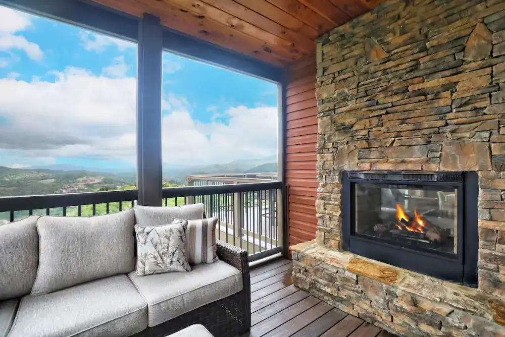 Outdoor living area and fireplace with Smoky Mountain views. 