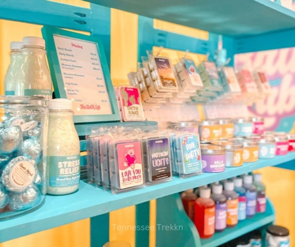 A display of The Bath Lab’s handmade products on a market shelf, showcasing bath bombs, scrubs, and more.