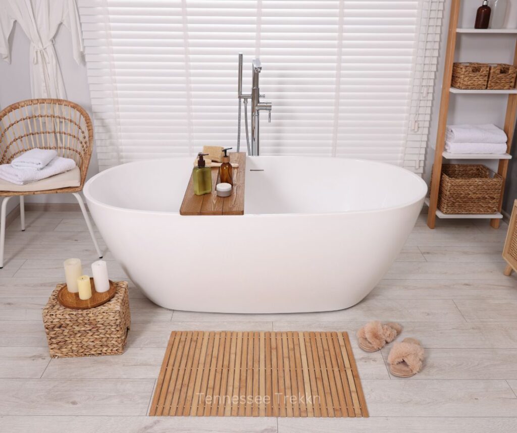 A bathtub with a bath tray holding a candle from The Bath Lab, perfect for creating a relaxing soak.