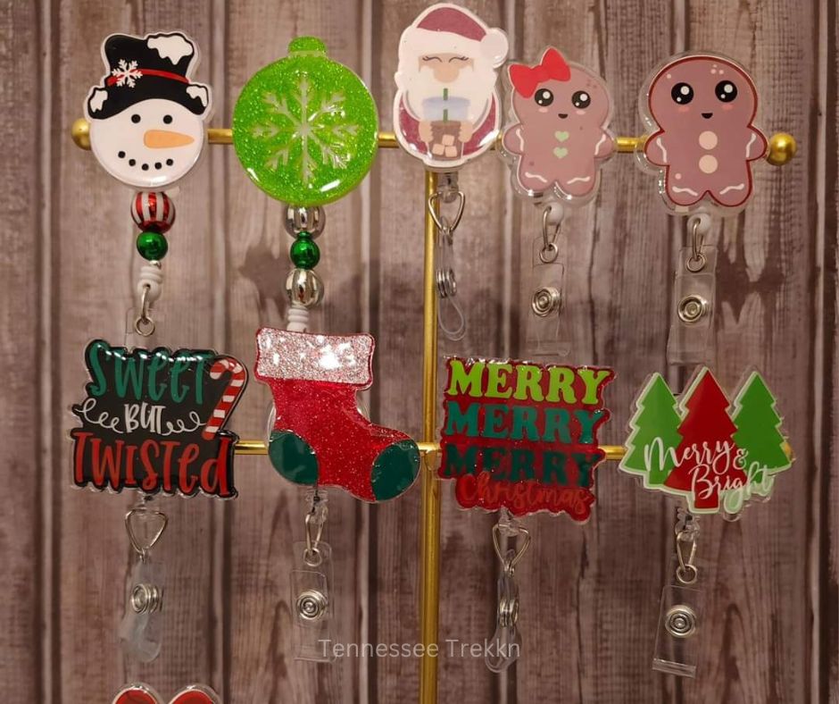 A collection of Christmas-themed badge reels handmade by Tennessee creators, perfect for adding holiday cheer to work attire.