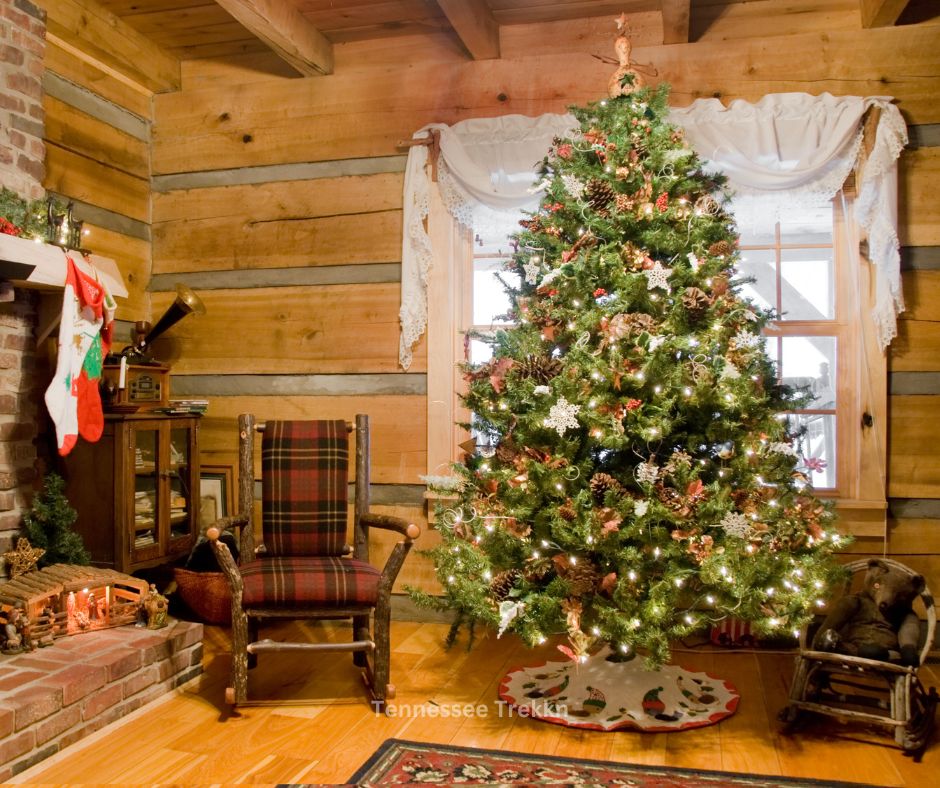  Tree decorated with ornaments and lights in cabin with a rocking chair. 