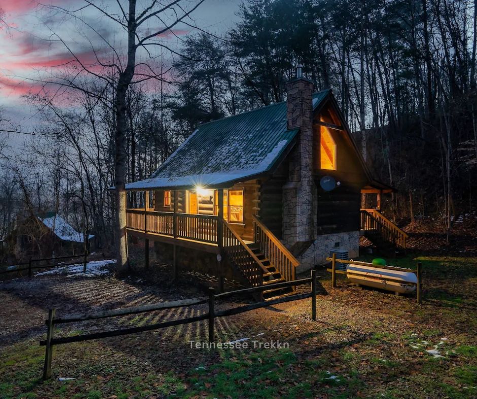 A private cabin glowing warmly at night, offering a cozy and welcoming retreat in the Mountains.