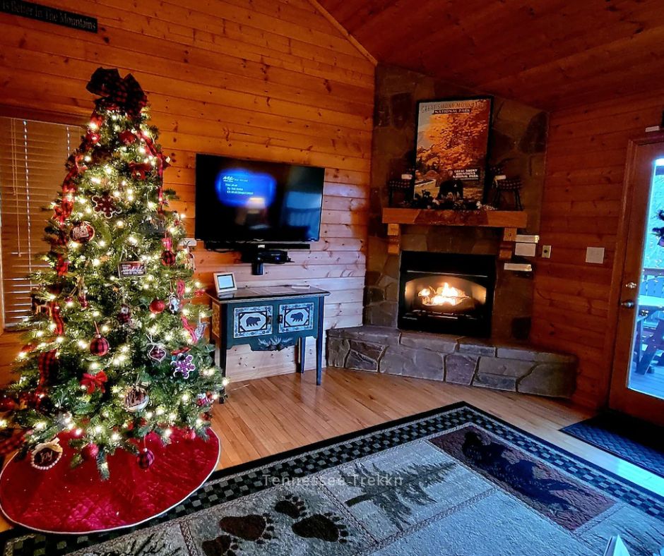 A beautifully decorated Christmas tree in the living room of Moonbeams and Star Dreams, a cozy cabin in the Smokies.