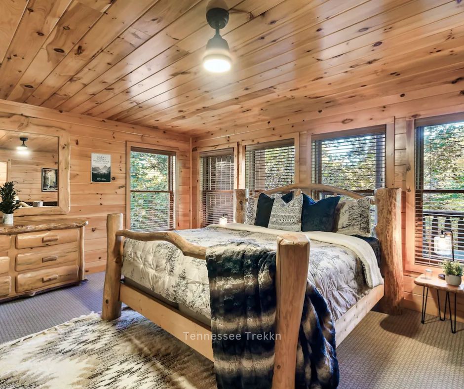 A warm and inviting bedroom at Mountain Bliss, featuring plush bedding and a festiveatmosphere in the mountains.