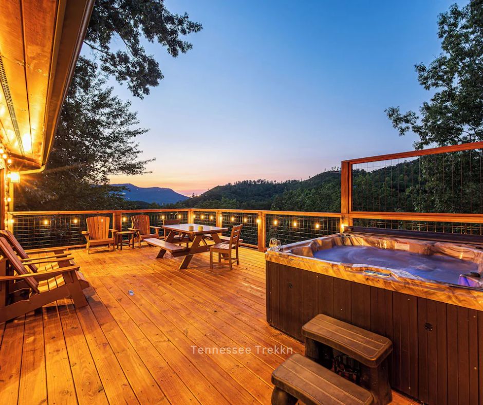 An outdoor hot tub at Pine Splendor, a Christmas cabin in the Smokies, with mountain views and festive ambiance.