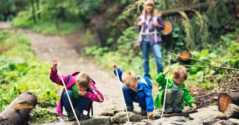 Children exploring a creek outdoors, representing outdoor gifts for kids that inspire nature play and adventure.