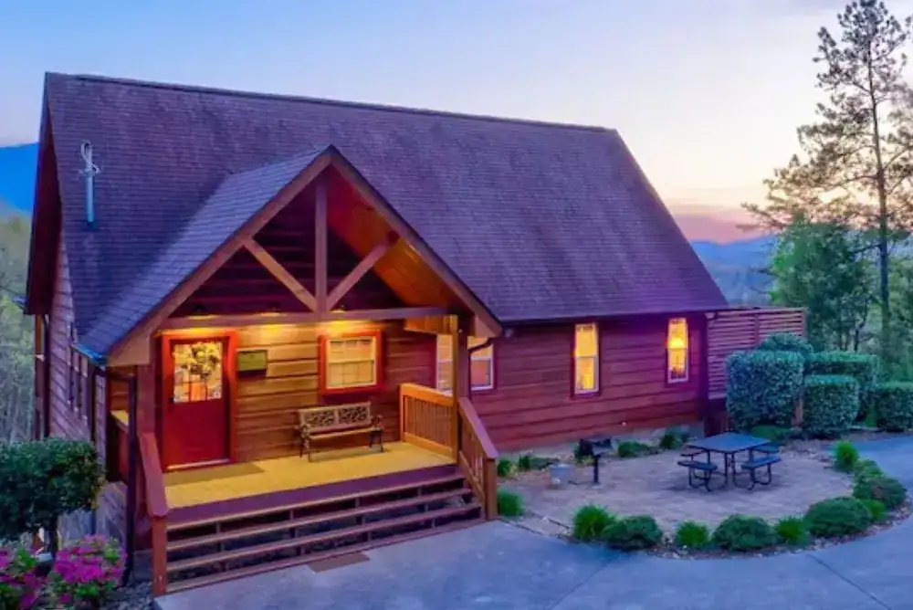 Cozy cabin exterior in the mountains.;