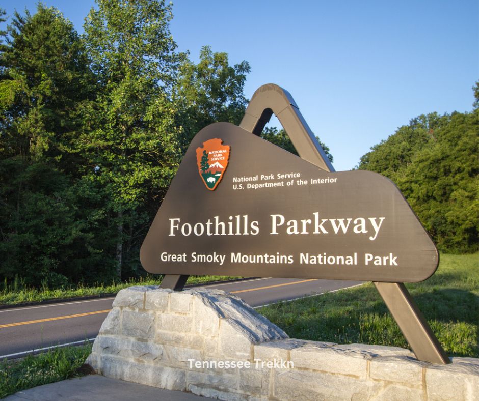 A Foothills Parkway sign surrounded by lush greenery, marking the entrance to one of Tennessee’s most scenic drives.