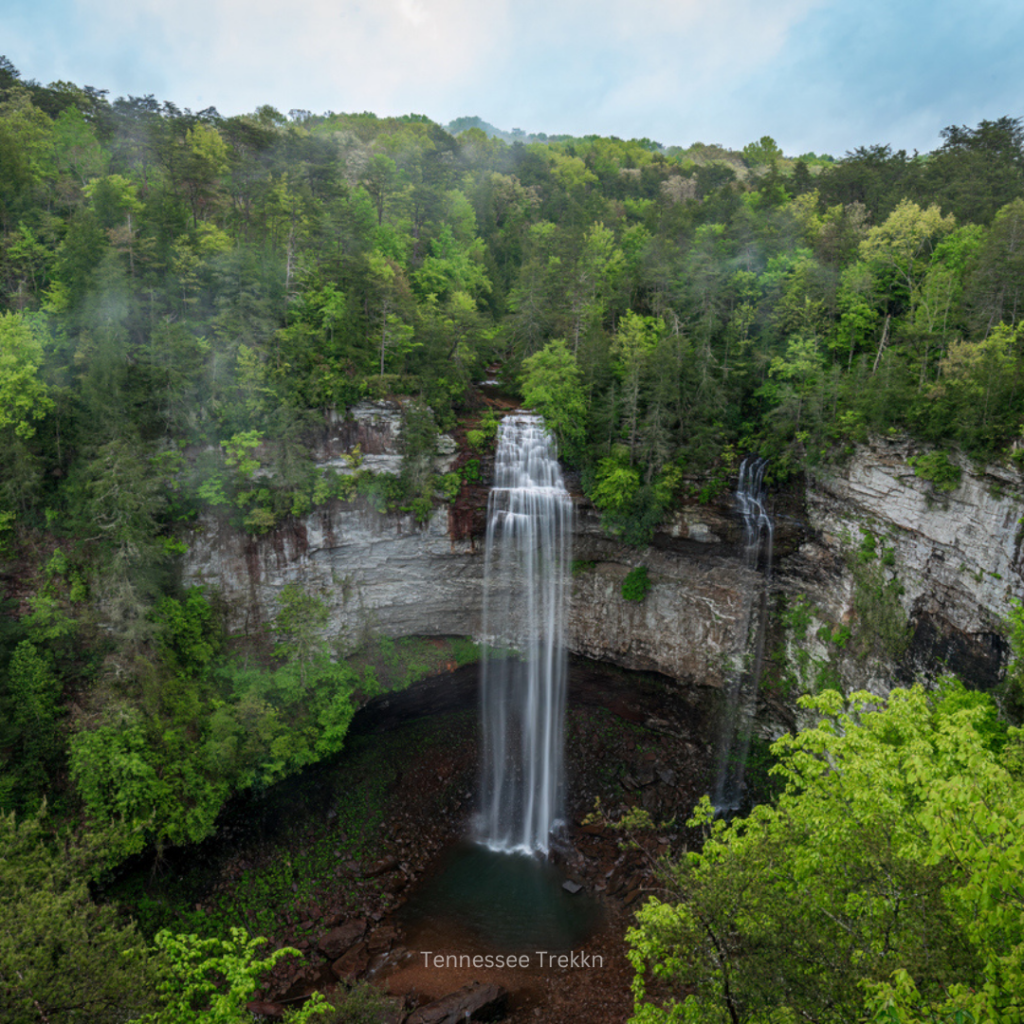 A stunning view of Fall Creek Falls, the tallest waterfall in Tennessee, surrounded by lush greenery in Fall Creek Falls State Park. 2025 Tennessee Bucket list idea!