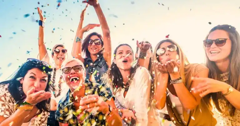 "Group of girlfriends smiling and tossing confetti during a fun girls weekend in Chattanooga, TN"