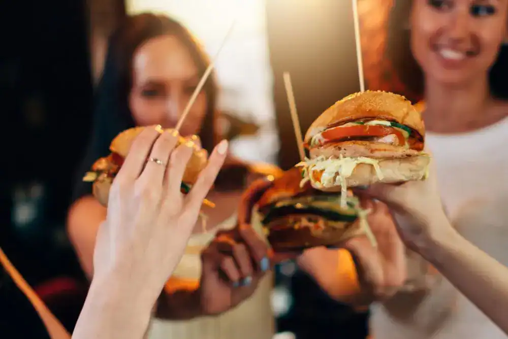 Friends enjoying burgers during a girls’ trip in Tennessee.