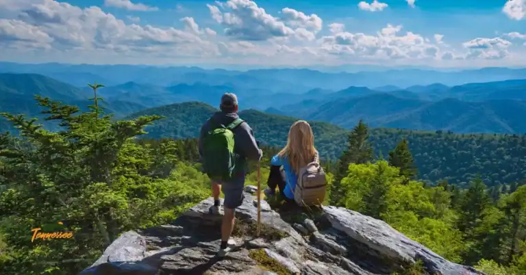 Woman with a backpack looking out over the Smoky Mountains — capturing the concept of backpack essentials for hiking in Great Smoky Mountains National Park.