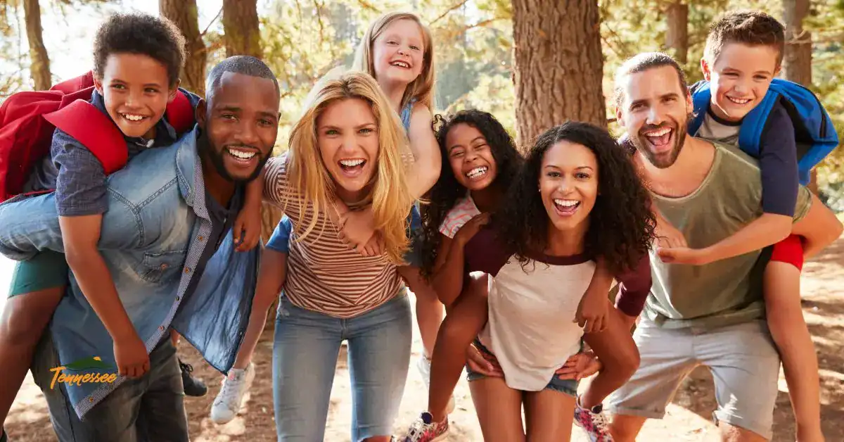 Family and kids smiling together in the woods, representing free and family-friendly outdoor fun in Pigeon Forge and the Smoky Mountains