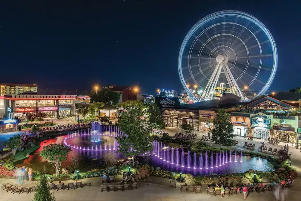 The Island in Pigeon Forge at night with the lit up Ferris wheel and colorful fountain show — one of the best free things to do in Pigeon Forge Tennessee on your family trip
