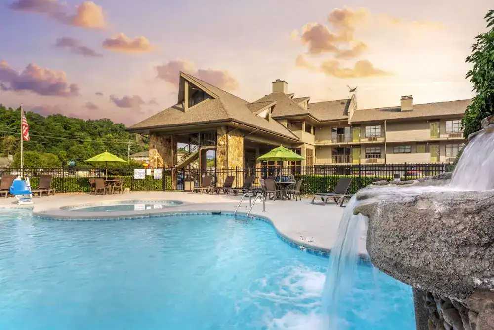 Outdoor pool with a waterfall feature at Best Western Plaza Inn, a budget-friendly hotel in Pigeon Forge, Tennessee.