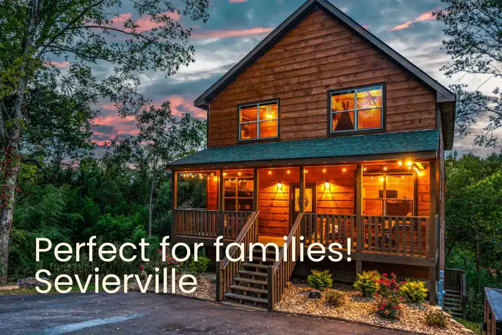 Family-friendly Sevierville cabin rental in the Smoky Mountains glowing at night with warm lights and cozy charm