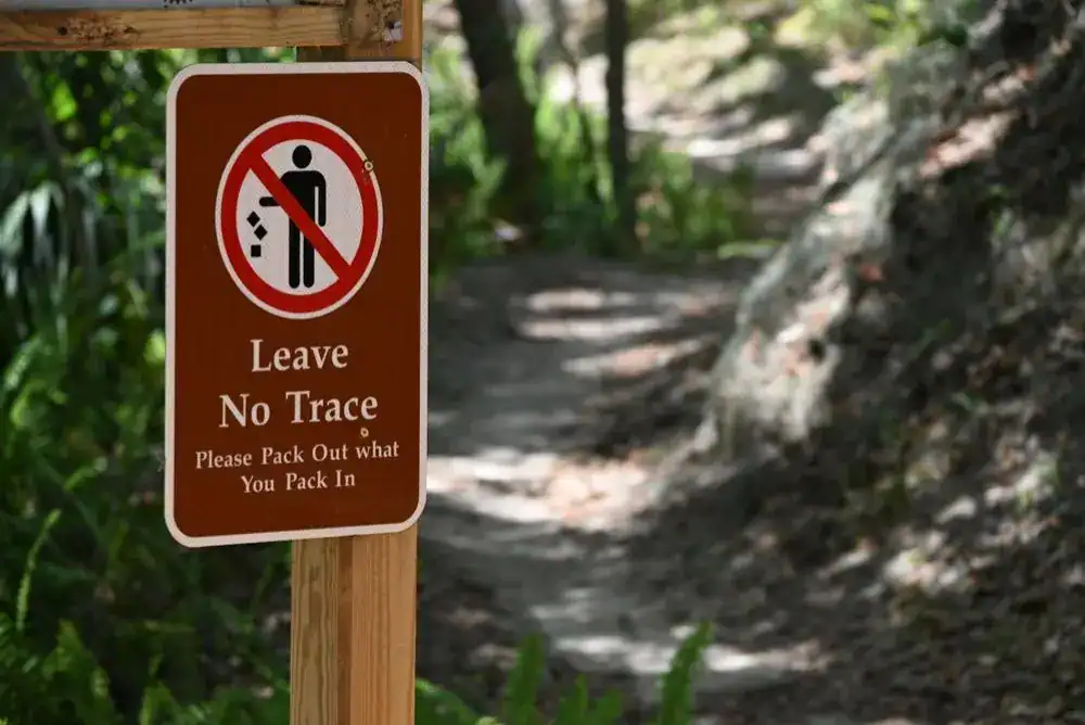 Leave No Trace sign posted at the start of a hiking trail in the Smoky Mountains, reminding visitors to protect nature.

