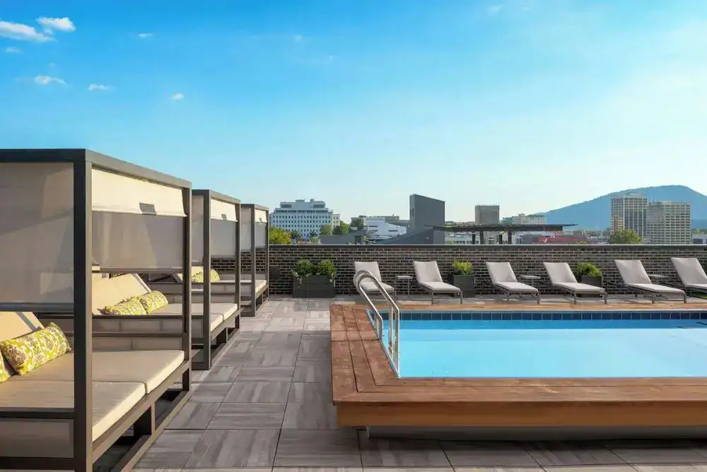 Rooftop pool with lounge chairs and scenic Chattanooga views

