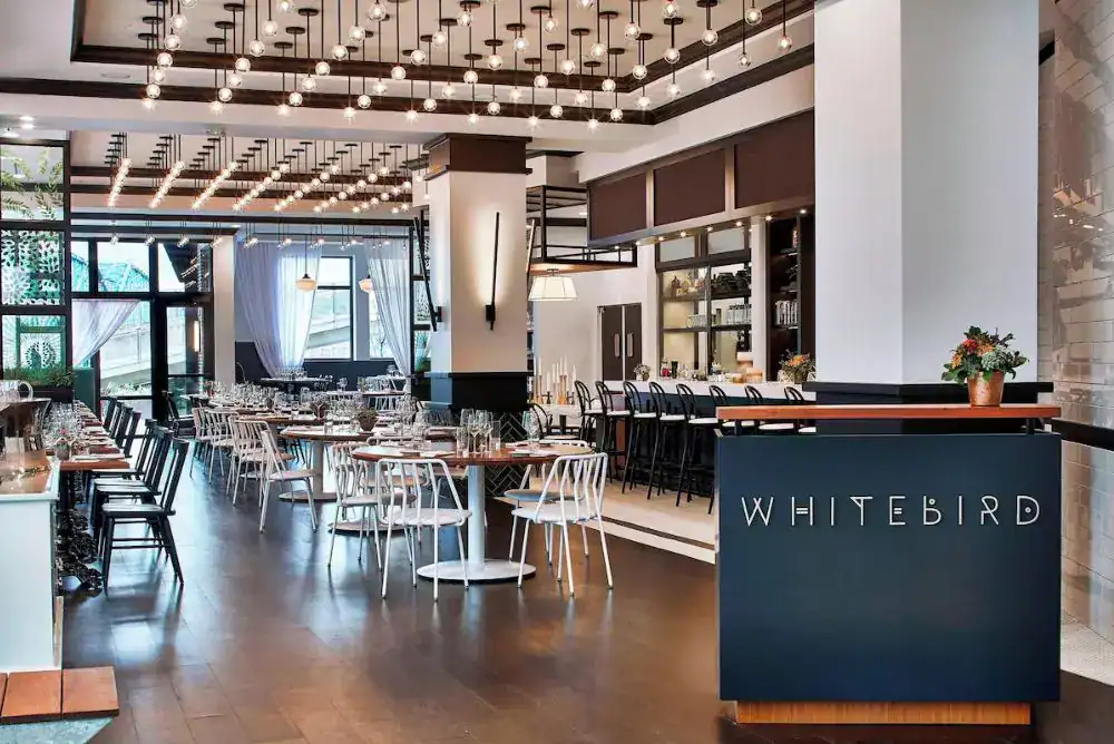 Cozy dining area at Whitebird restaurant with elegant table settings


