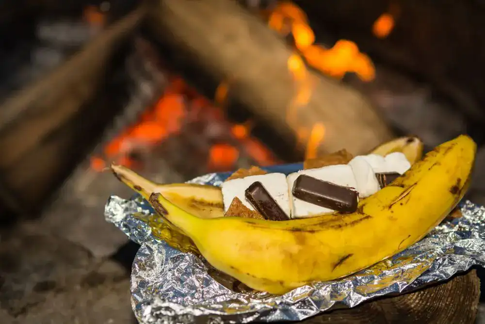 Banana boat s’mores with gooey marshmallows and chocolate by the campfire – a fun twist on classic s’mores recipes.