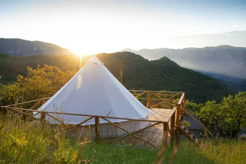 Cozy glamping campsite at sunrise with mountain layers in the Great Smoky Mountains.