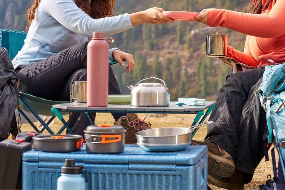 Campers enjoying a meal at the campsite using camp kitchen essentials