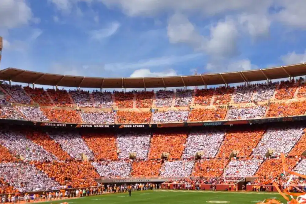 Checker Neyland at Neyland Stadium packed with Tennessee football fans in orange and white, a backdrop for the Tennessee Vols game day cocktail post.